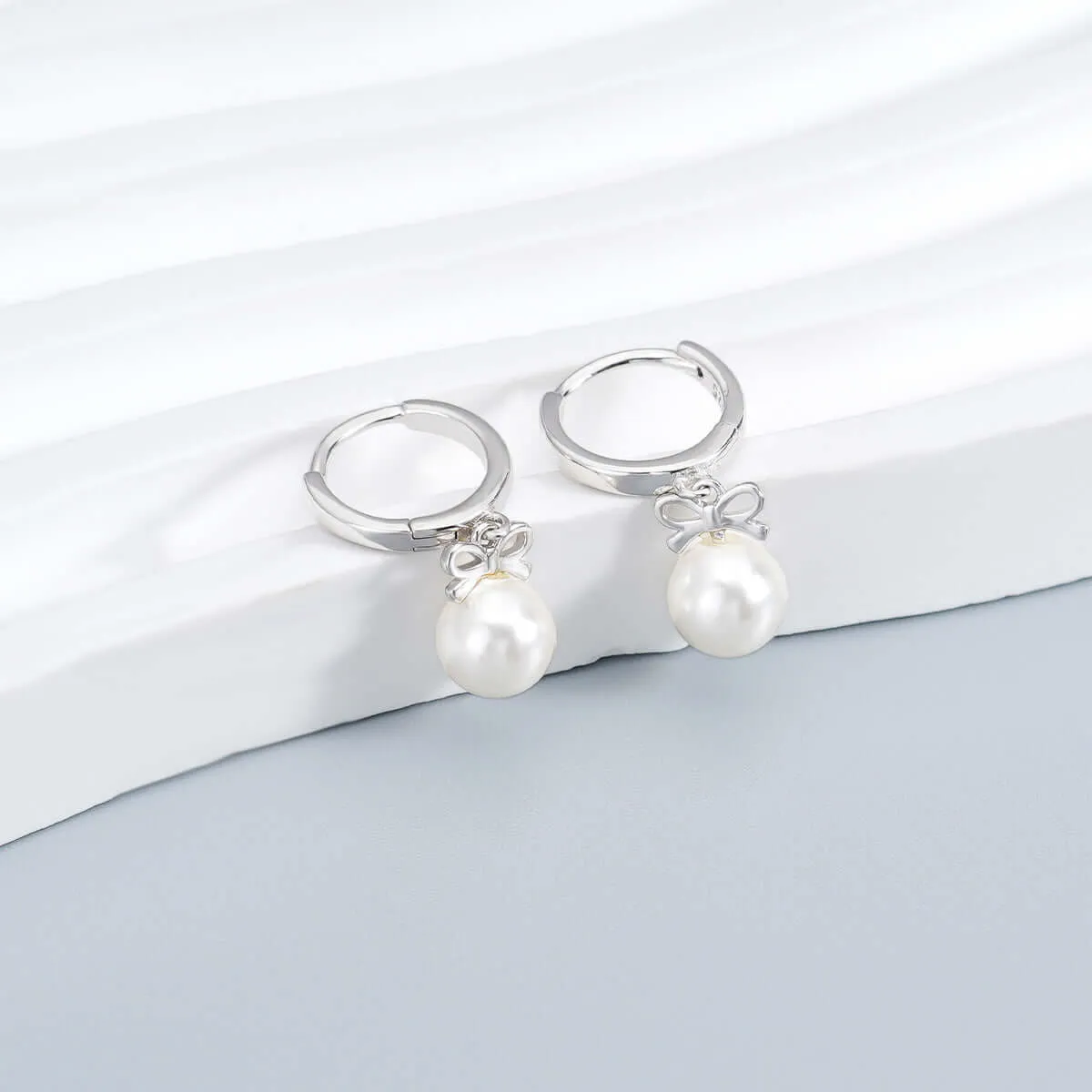 925 Silver Bow Pearl Huggie Earrings